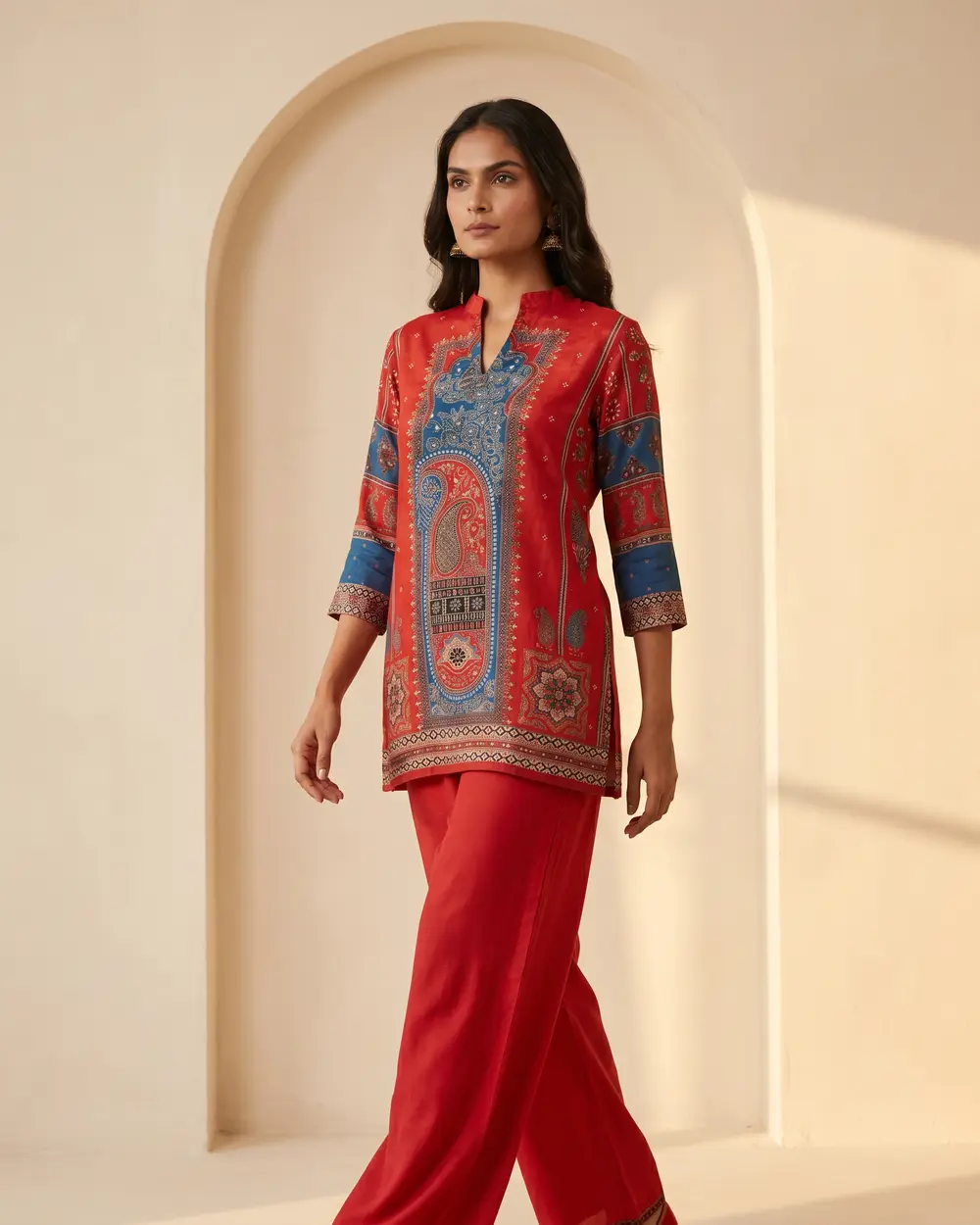 Model in a red festive-print kurta set with contrasting blue detailing